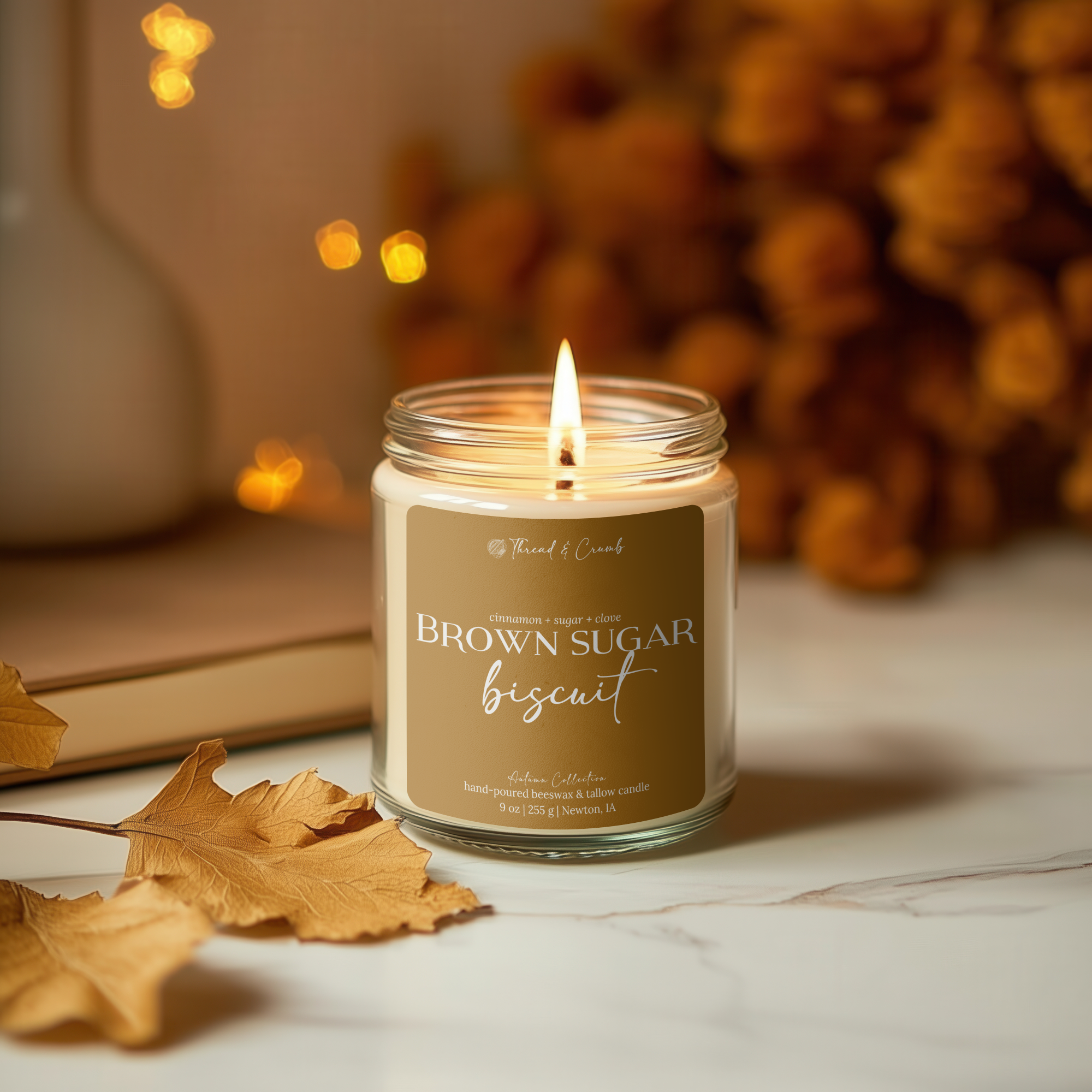 Candle labeled 'Brown Sugar Biscuit' with a blurred background of books and lights.
