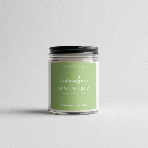 Front view of the handmade Cucumber Mint Spritz beeswax and tallow candle in a clear glass jar.