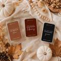 Three wax melts in clear clamshell containers from Thread & Crumb, arranged in a styled flat-lay with autumn props including pumpkins, dried leaves, a wooden bead garland, and a cream fabric background. The labels read Pumpkin chai, Haunted Library, and Twilight Grove.