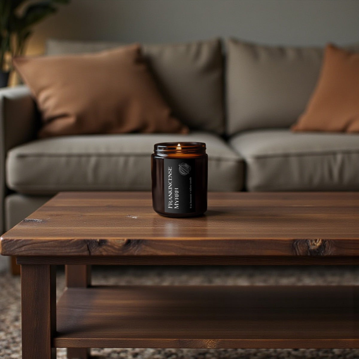 Frankincense and Myrrh candle burning on a rustic wooden coffee table in front of a neutral sofa