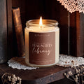 Haunted Library fall beeswax and tallow candle with aged pages, incense and tobacco fragrance notes styled on a vintage bookshelf.