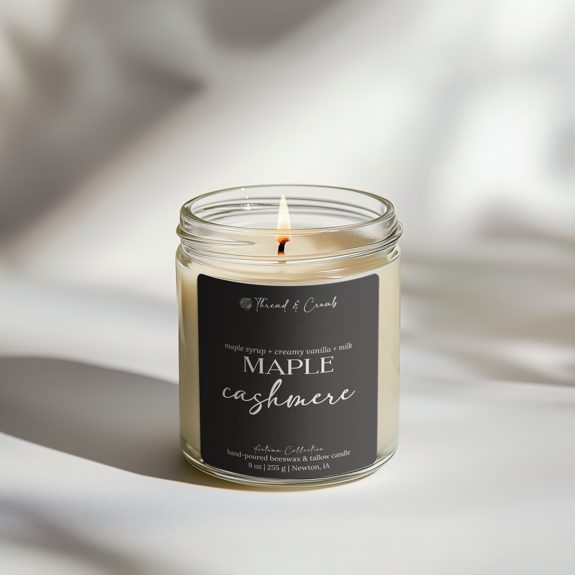 Front view of the handmade Maple Cashmere beeswax and tallow candle in a clear glass jar.