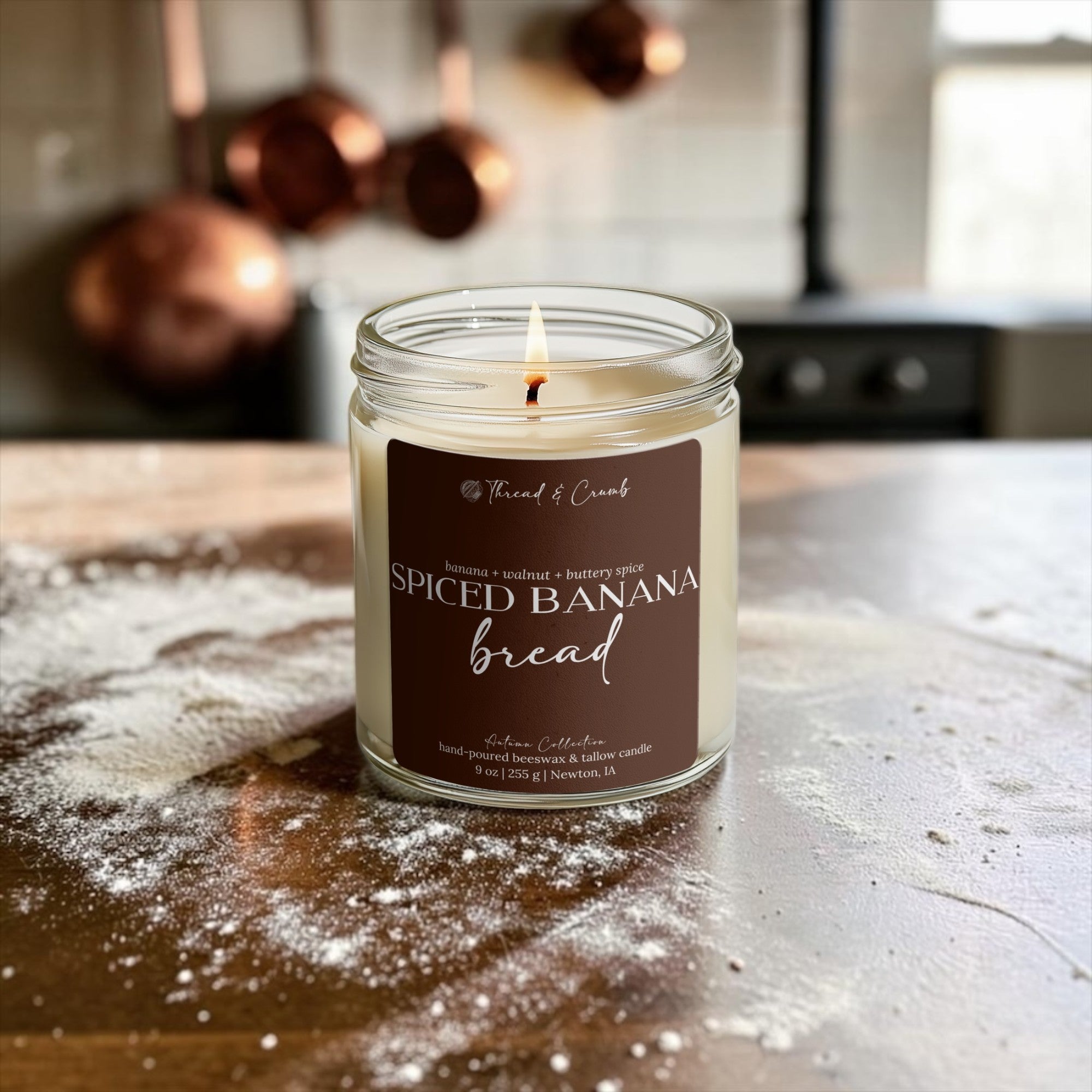 Spiced Banana Bread beeswax and tallow candle styled on a floured kitchen counter with warm baking details
