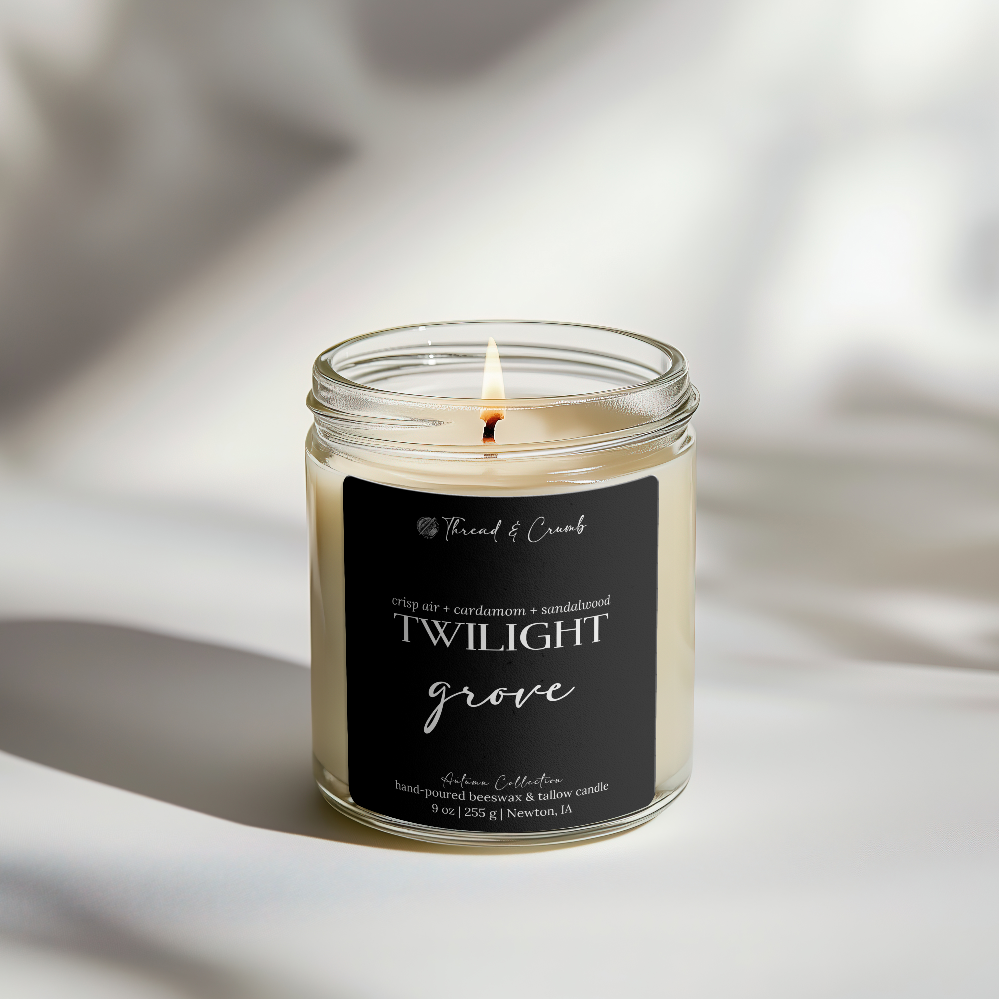 Front view of the handmade Twilight Grove beeswax and tallow candle in a clear glass jar.