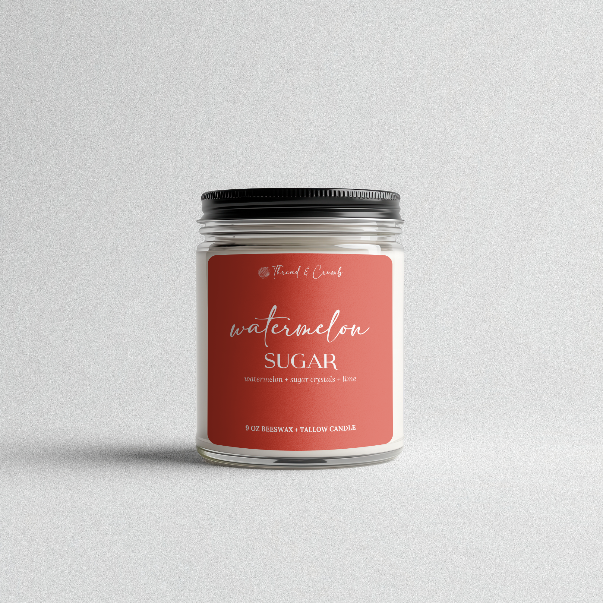 Front view of the handmade Watermelon Sugar beeswax and tallow candle in a clear glass jar.